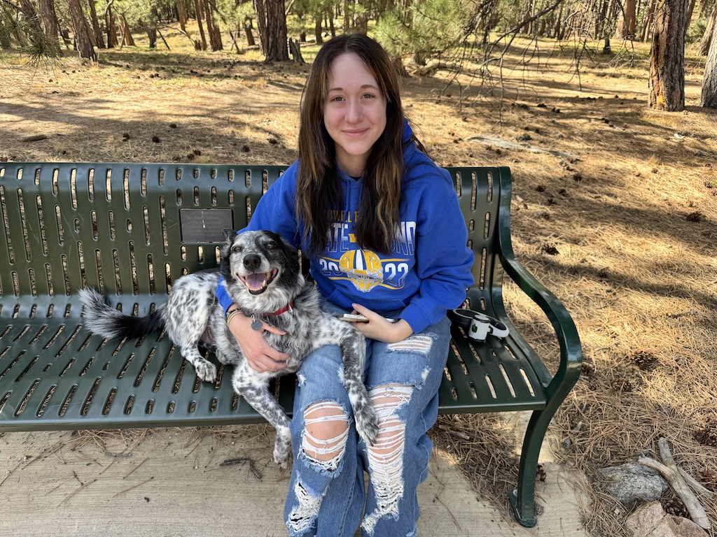 Banzai sitting happily on a bench with his family.